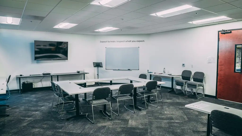 Training room at the OctoClean headquarters with U-shaped tables and a whiteboard
